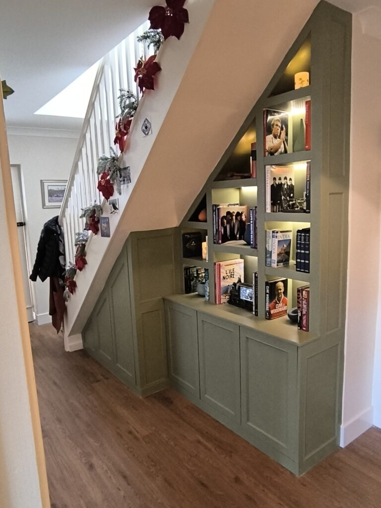 Bespoke understairs storage with fitted cupboards and shelving, custom built and installed in Dorset