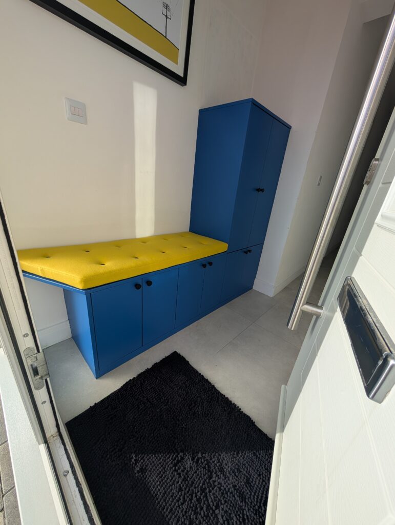 Built-in shoe storage bench seating with cupboard doors and internal shelving for concealed storage